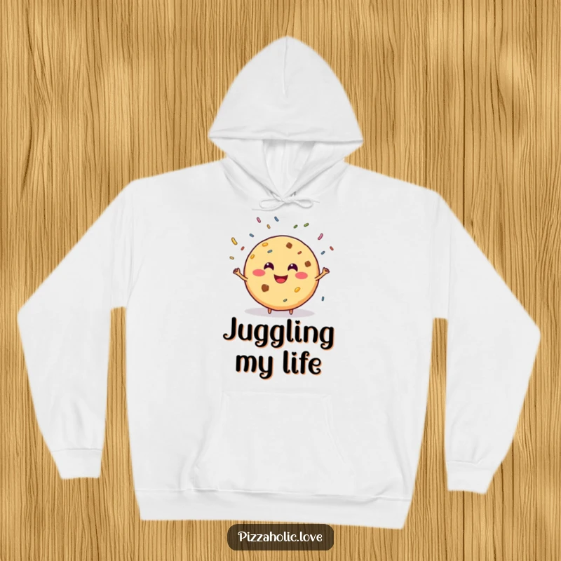 Funny hoodie featuring a smiling, round cookie with a grin, juggling sprinkles, designed for cozy, playful vibes.